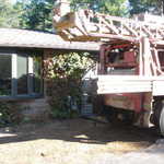 Getting drill rig set up next to failing point well.