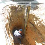 Welding on the pitless adapter to connect well to house.